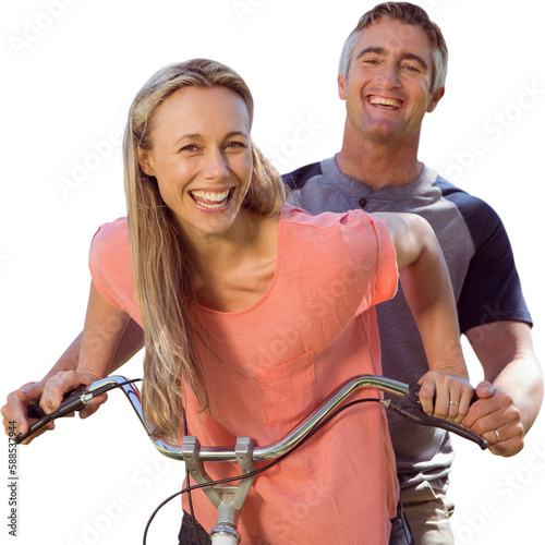 Mature couple cycling while smiling