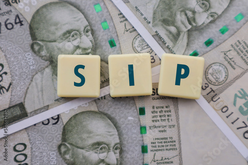 Mutual Fund SIP written on Tiles on Indian Rupee Notes - Systematic Investment Plan