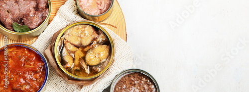 Canned vegetables, beans, fish and fruits in tin cans on a white background. Food stocks.