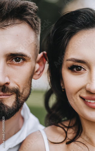 Wedding photography, close-up portrait of two faces of a bearded groom and a brunette bride.