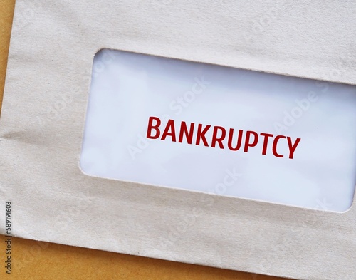 Envelope with text BANKRUPTCY - legal process when one cannot repay debts to creditors and seek relief from some or all debts - imposed by court order