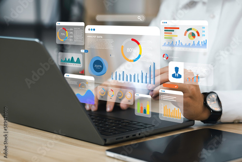 An analyst uses a computer and dashboard for data business analysis and Data Management System with KPI and metrics connected to the database for technology finance, operations, sales, marketing 