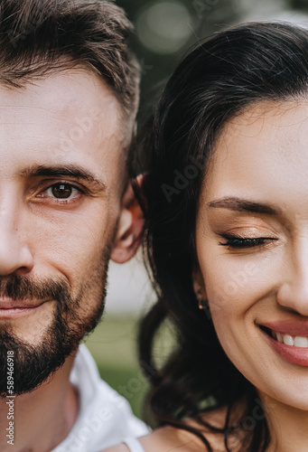Wedding photography, close-up portrait of two faces of a bearded young brunette bride and groom with curly hair.