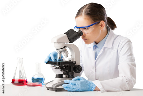 Young scientist looking through a microscope in the laboratory.