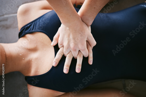 Hands, cpr and first aid with help of lifeguard for emergency, drown or accident after swimming. Sports, breathing and resuscitation of woman, rescue of athlete or saving life of swimmer in top view.