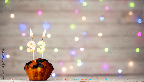Happy birthday background with muffin and number of candles on light bulbs bokeh background. Greeting card happy birthday copy space with number 93