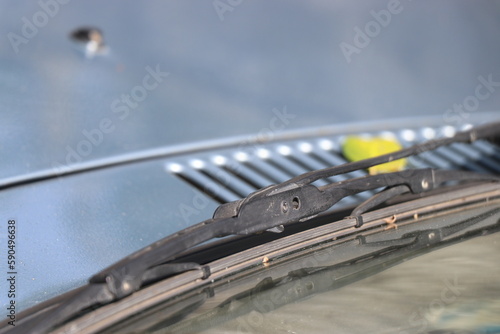 View of a car wiper placed on a windshield on a natural light