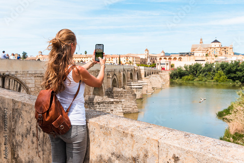 Woman taking photography with smartphone the view of Cordoba city - Spain, Andalusia
