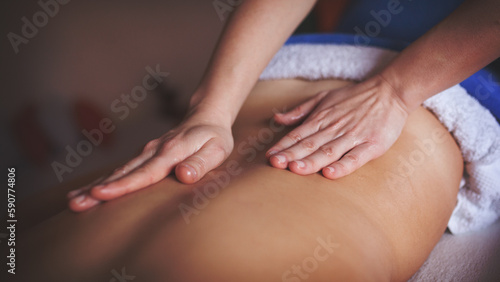 A beautiful masseuse performs massage therapy in a private SPA center while a beautiful woman enjoys the charms of massage