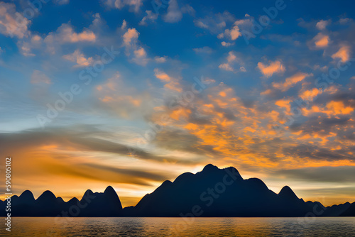 Orange sunset over beautiful dark mountains. Beautiful clouds and a calm lake. AI-generated