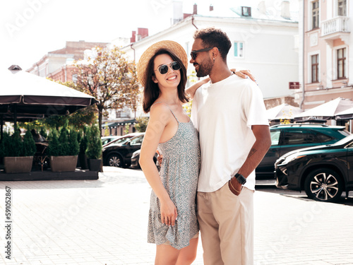Smiling beautiful woman and her handsome boyfriend. Woman in casual summer clothes. Happy cheerful family. Female having fun. Sexy couple posing in the street at sunny day. In hat and sunglasses