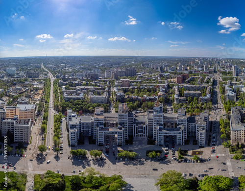 Aerial wide-angle panorama of Derzhprom building on Freedom Square in green spring Kharkiv city center, Ukraine. Constructivist architecture