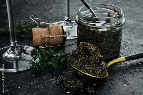 Beluga black caviar and toast bread. Preparation of luxury snacks. On a concrete background.