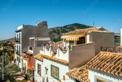 Finestrat, Alicante province, Spain. Panorama of picturesque Finestrat village old town with cozy houses roofs, beautiful quiet narrow streets at sunny day