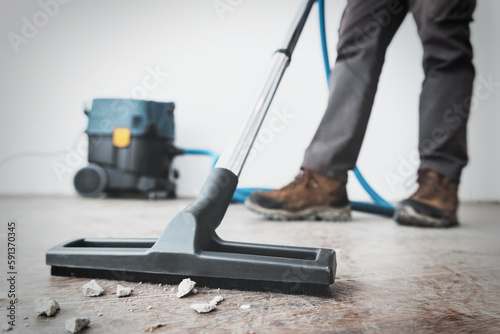 Professional construction cleaning service with powerful vacuum cleaner.