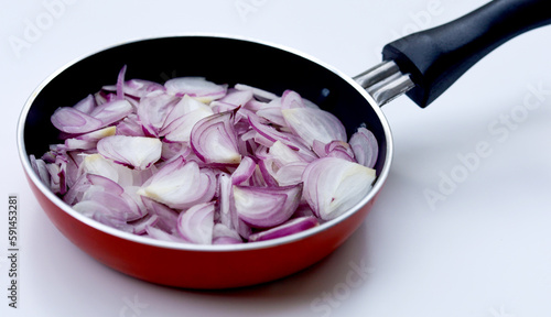 Sliced onions or shallots on frying pan - top view