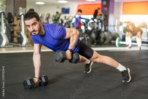Workout And Dumbbell Push Up At Gym For Muscle, Power Or Strength. Young Athlete Man Exercises And Trains His Body To Keep Fit And Lead A Healthy Life