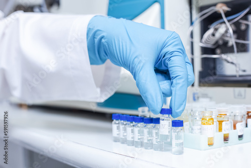 A hand of scientists arrange vials of samples in order of sample or prepare samples for analysis by Liquid Chromatography mass spectrometry LC-MS analysis in lab. LC-MS is used for scientific research