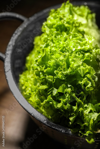 Fresh lettuce on brown table, closeup. Salad greens