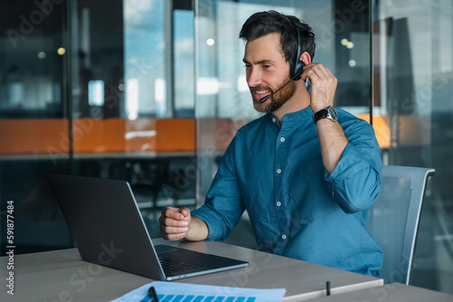 Male manager in headphones having a video call