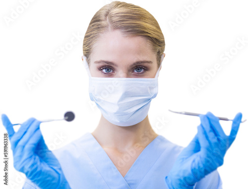 Portrait of female dentist holding dental equipment