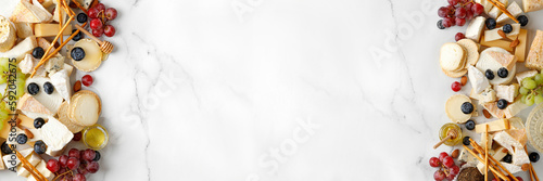 Cheese banner, assortment of traditional cheese, brie, gorgonzola, lambert, livaro, raclette. Antipasto, corner border, copy space. Marble white background, top view.