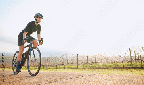 Cycling, fitness and mockup with woman in park for training, workout and cardio health. Exercise, travel and freedom with female cyclist riding on bike in nature for adventure, journey and transport