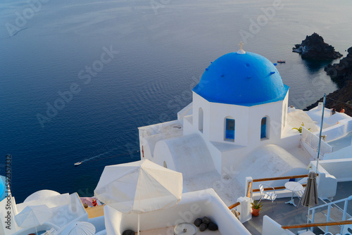 traditional greek village Oia of Santorini, with blue domes of churches and village roofs, Greece