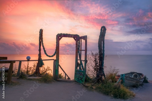Old metal door in background of sea during sunset in Vama Veche