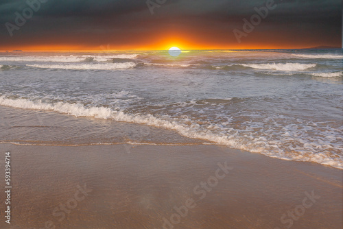Coastline of Sunset over the pacific ocean. Evening view on sand and surf view.