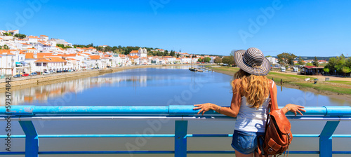 Woman tourist looking at panoramic view of Alcacer do sal, touristic village in Portugal- Alentejo