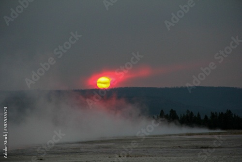 View of the sunset in the yellow sky in Yellowstone National Park.
