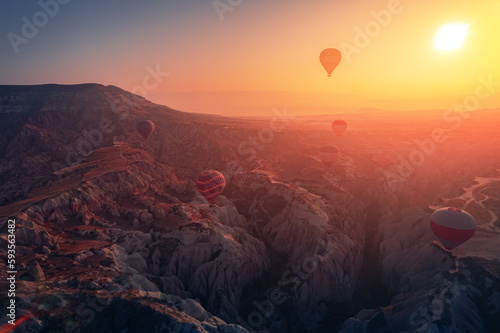 Beautiful sunrise landscape in Cappadocia with colorful hot air balloon deep canyons, valleys. Concept banner travel Turkey