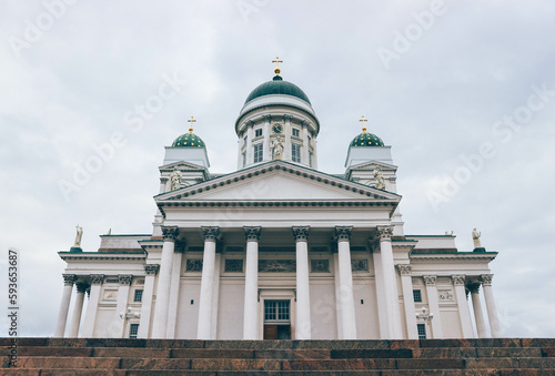 Minimalist look of lutheran finish cathedral over cloudy sky with green domes