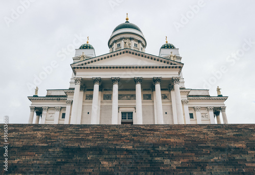 Minimalist look of lutheran finish cathedral over cloudy sky with green domes