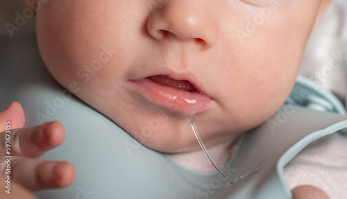 profuse salivation in infants from the mouth. The process of formation and eruption of teeth, close-up