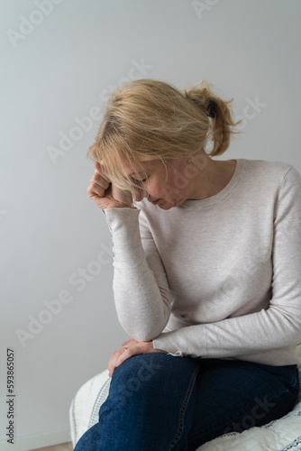 Depressed mature woman at home. Sad face with hands. Mental health problems, gaslighting or bulling at home