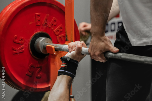 hand powerlifter hold bar barbell before bench press powerlifting competition, power sports games