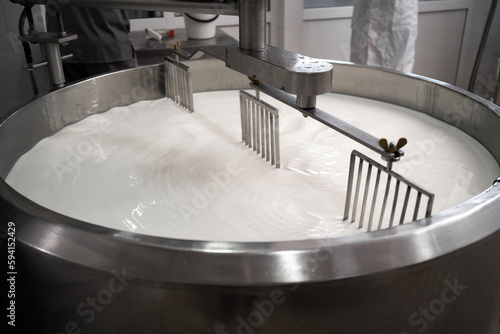 Process of making dairy products in modern dairy factory. Preparing milk for cheese, pasteurization in large tanks.