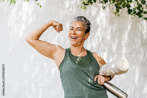 Fit and proud: Senior woman flaunts her bicep as she celebrates her fitness achievements