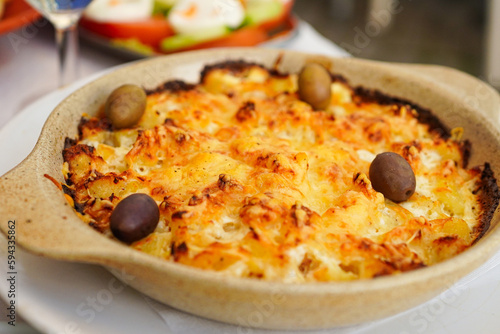 Bacalhau com Natas, most famous Portuguese dishes made with salted cod served in a mixture of cream, potatoes, and onion