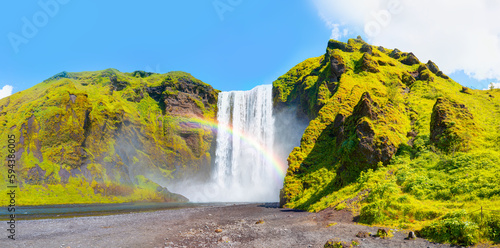 Icelandic Landscape concept - View of famous Skogafoss waterfall and amazing rainbow