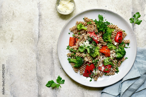 whole grain pasta fusilli with grilled bell pepper and broccoli. Top view with copy space.