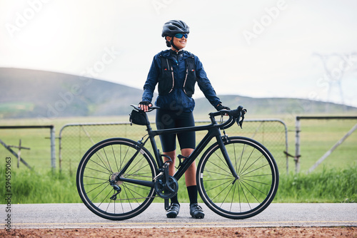 Fitness, bicycle and woman on break from cycling, sports and training in the countryside for morning cardio. Bike, ride and female cyclist relax, smile and happy during workout, exercise and travel
