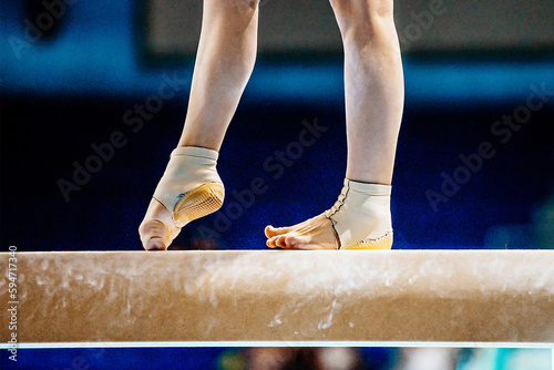 close-up legs female gymnast step on balance beam in gymnastics, fitted neoprene ankle support with heel cup