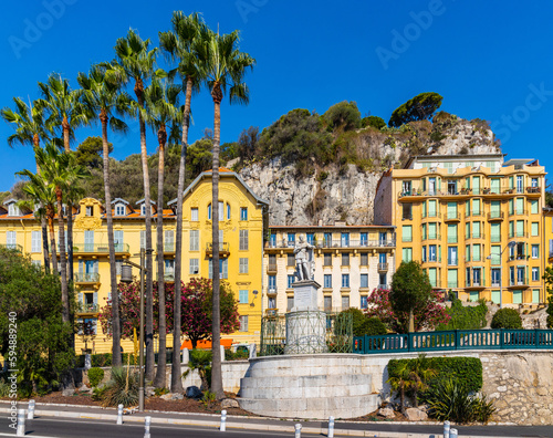 Colorful tenement houses along Rue de Foresta street with Charles Felix de Savoie statue in historic Nice Port district on French Riviera in France