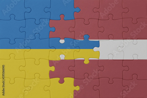 puzzle with the national flag of ukraine and latvia . macro.concept.