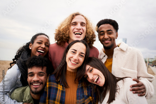 Happy friends from diverse cultures and races taking selfie outdoors. Cheerful people having fun. High quality photo