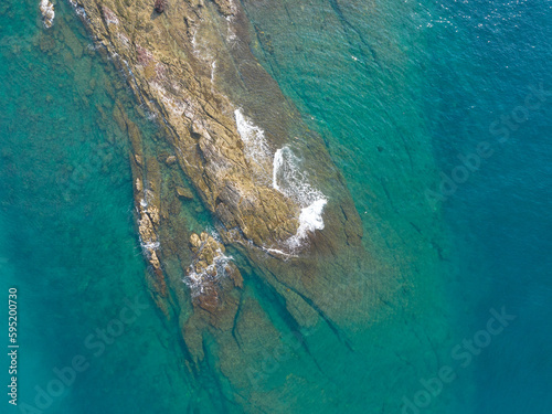 Aerial drone view of rocky coastline and beautiful turquoise sea water of Gulf of Thailand. Kood island, Thailand.