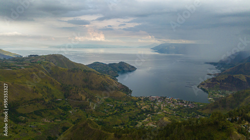 Beautiful Toba lake surrounded by mountains with tropical forest. Sumatra, Indonesia.